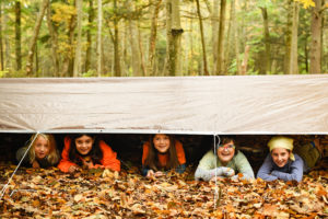 five students under a tarp